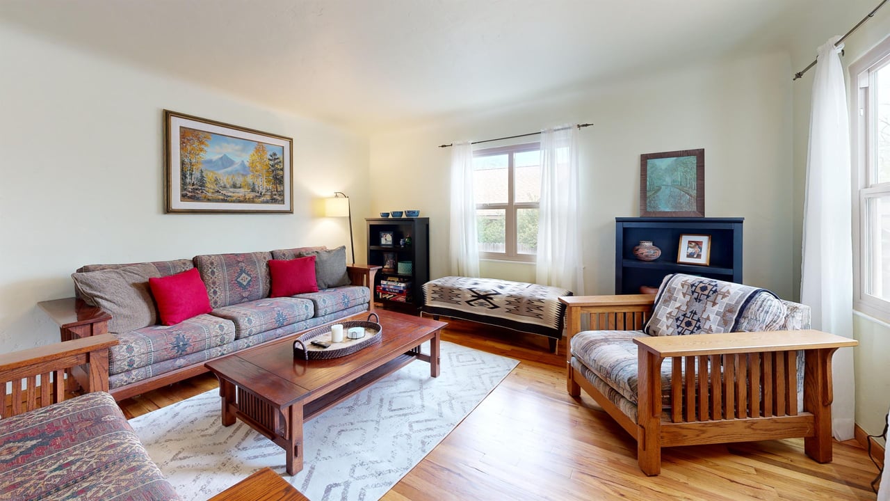 Cozy living room featuring a flatscreen TV, fireplace, and plenty of seating.