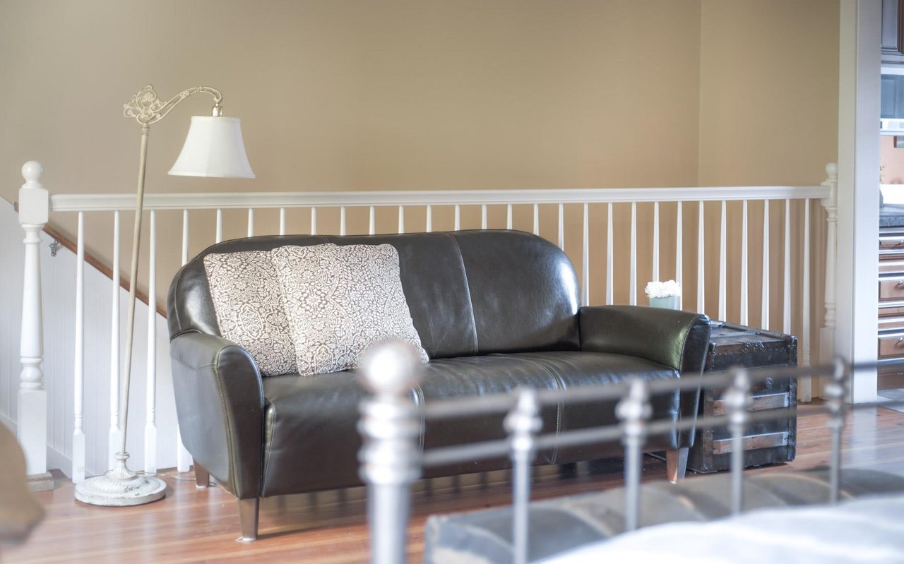 Watch from TV from the bed or the large leather sofa.