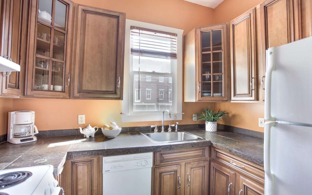 The kitchen is spacious for a studio apartment.