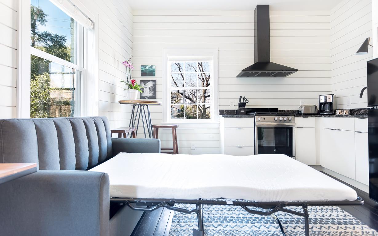 A sleeper sofa conveniently placed for a third traveler.