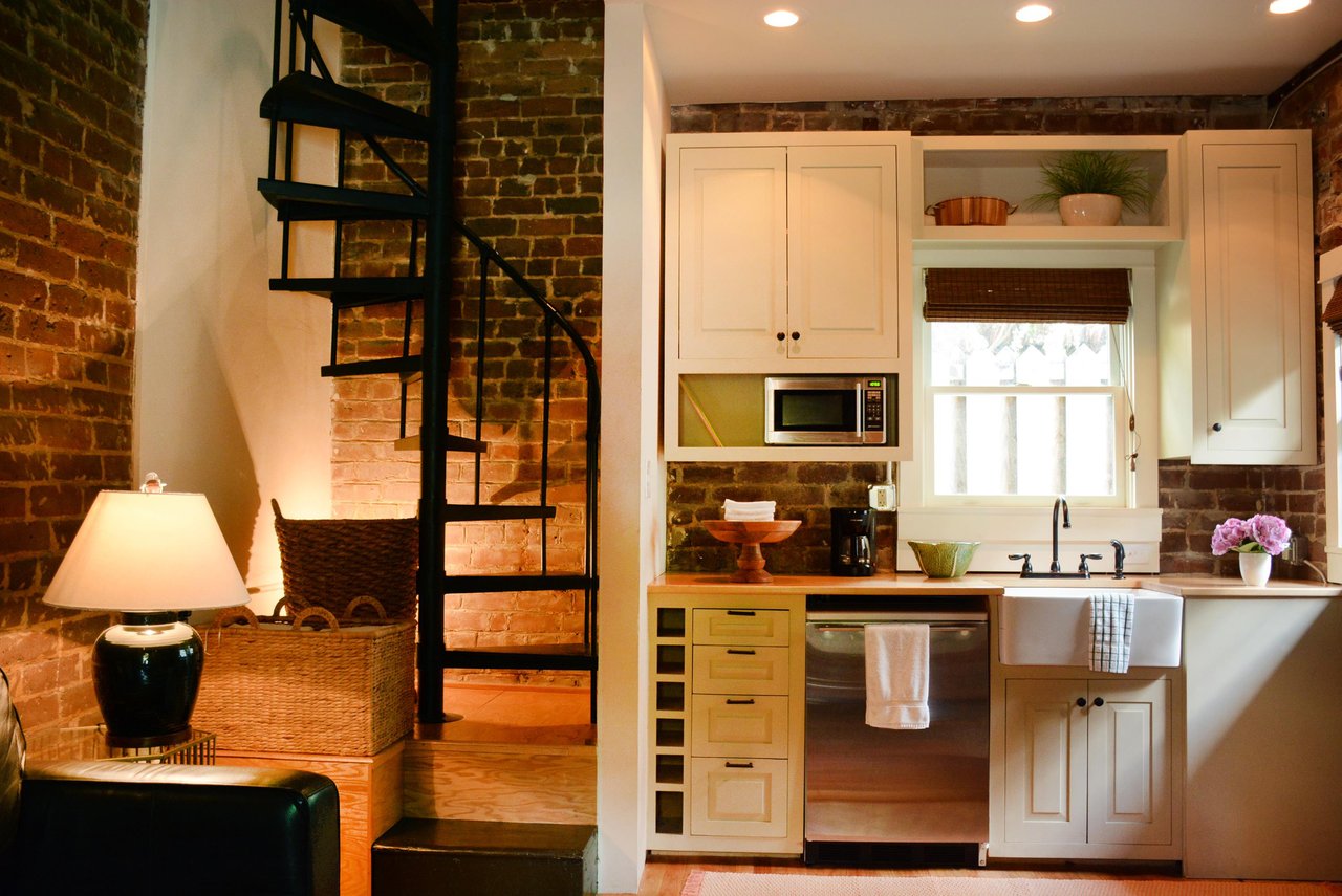 The spiral staircase leads up to the bedroom.