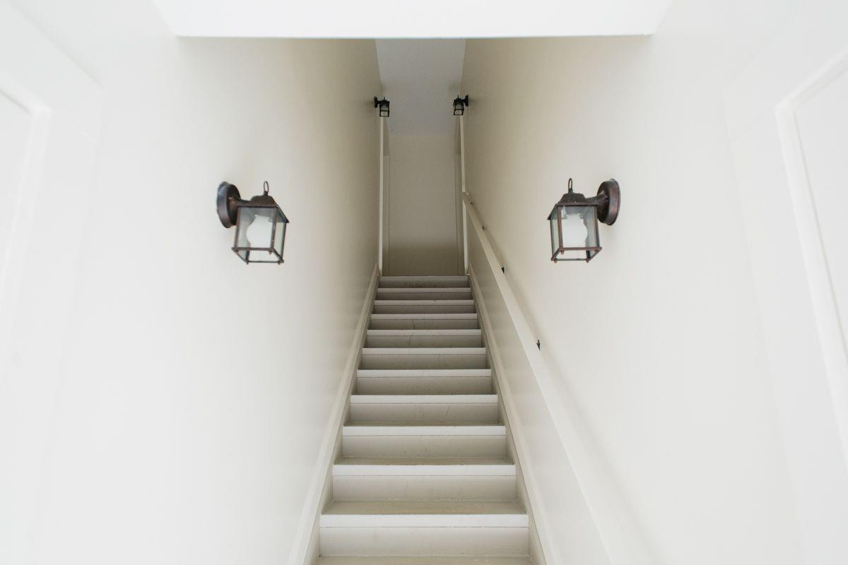 Head through the courtyard, and head upstairs to the carriage house.