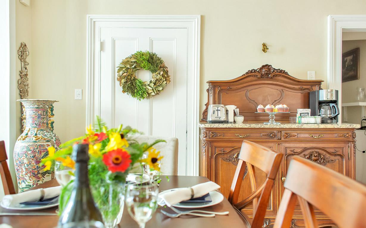 An antique buffet holds the coffee maker and toaster.