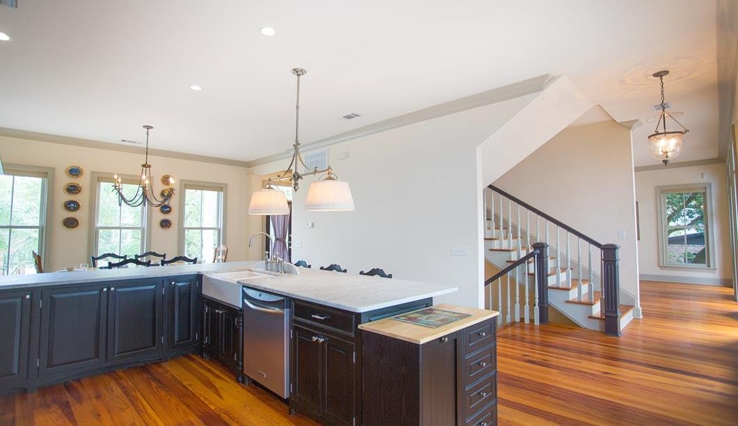 This huge kitchen has a breakfast bar.