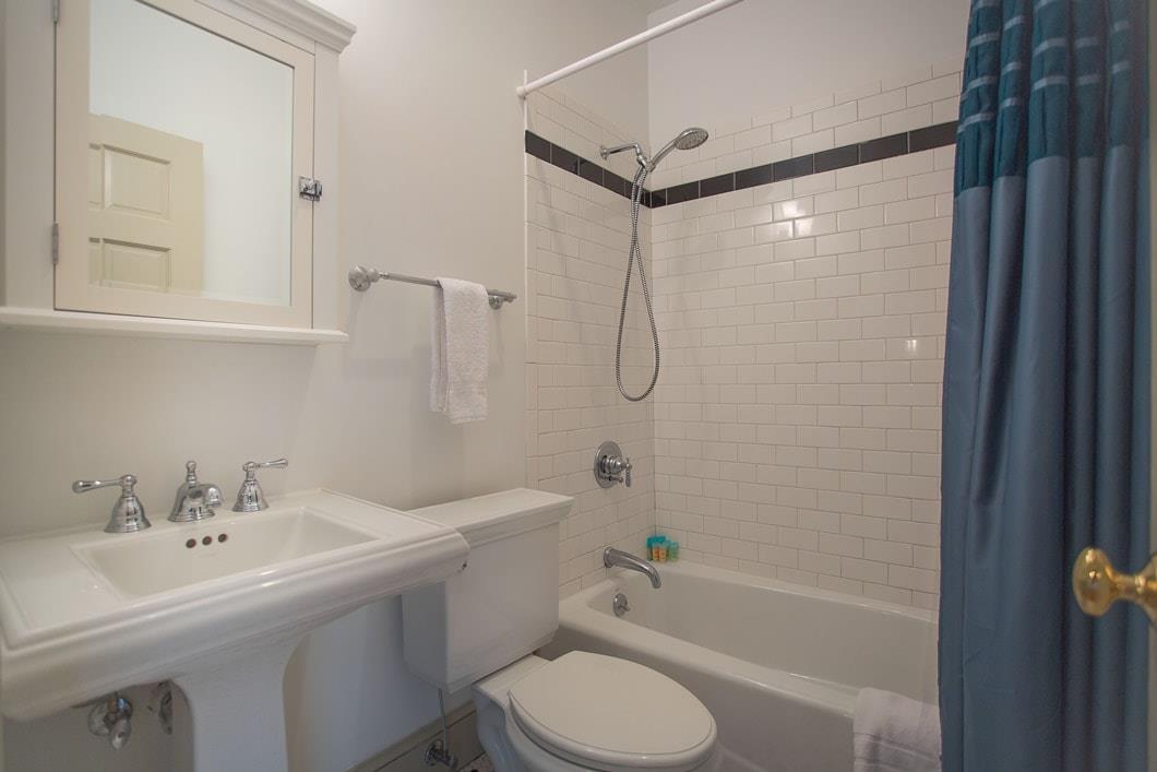 Updated bath and shower combo with modern subway tile.