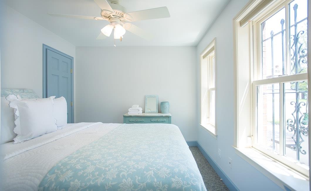 First queen bedroom on the garden level gets lots of light from the private courtyard.