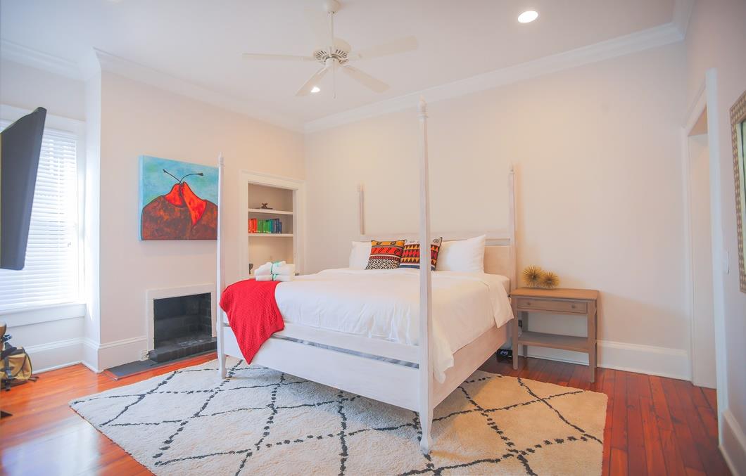 The primary suite showcases a king size four poster bed.