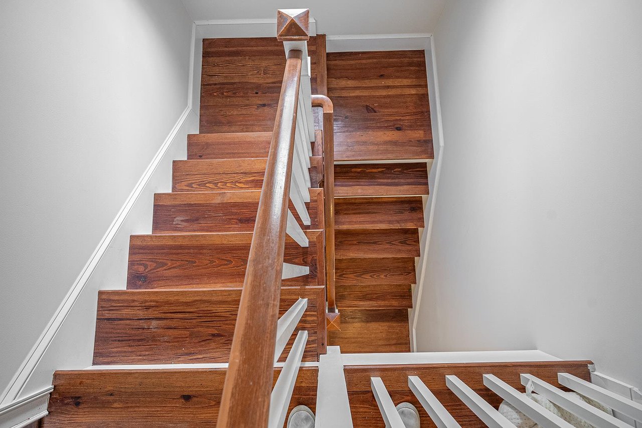 Staircases are located at the front and back of the home will take you to all four floors of this historic mansion.