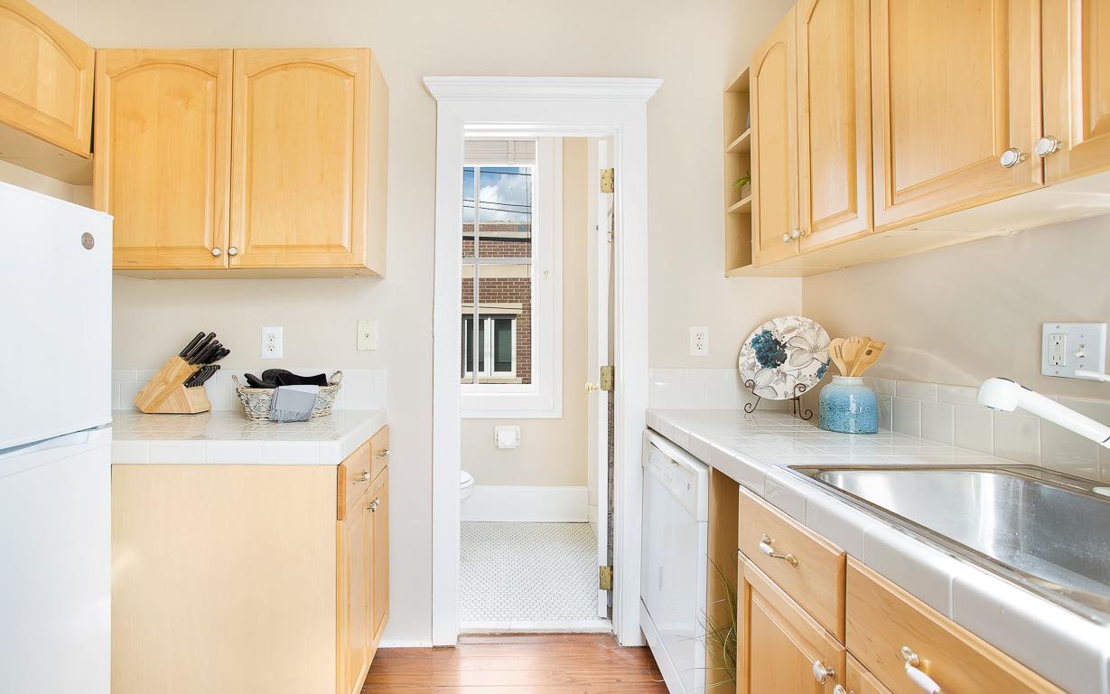 The kitchen leads into the bathroom.