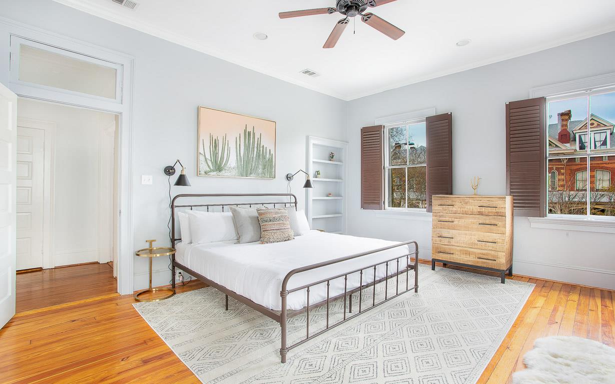 An ample amount of light floods this bedroom  Shut the blinds for a quiet nights rest.