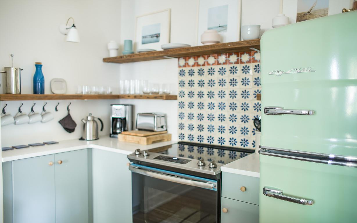 Expect a full size fridge, stainless steel appliances, and plenty of dishes.