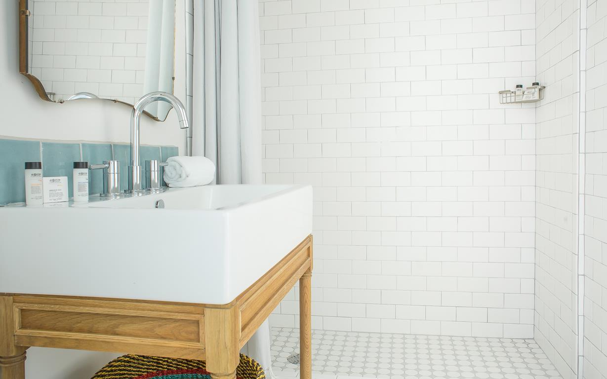 Guests will enjoy the standing shower with subway tile.
