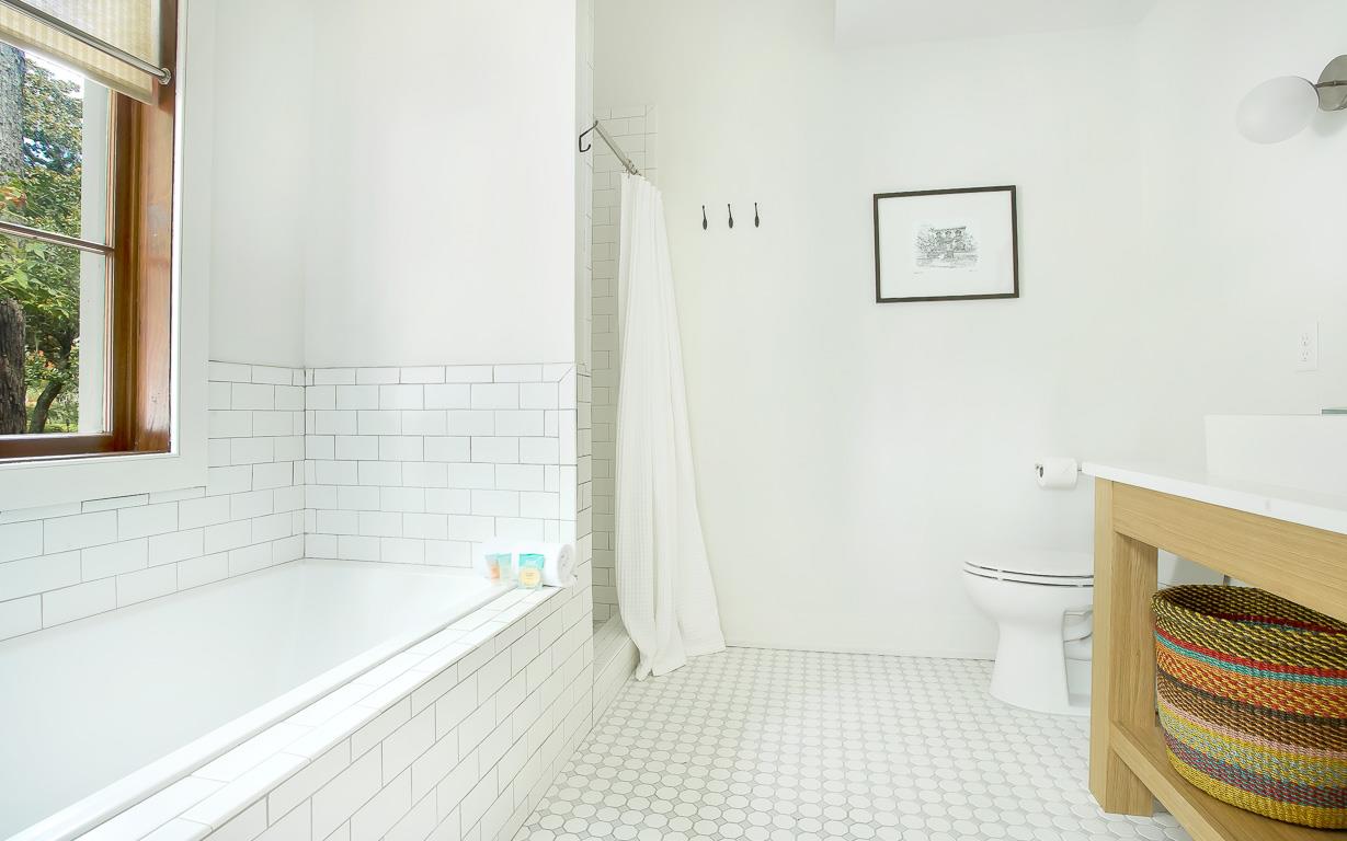 A standing shower hides behind the soaking tub.