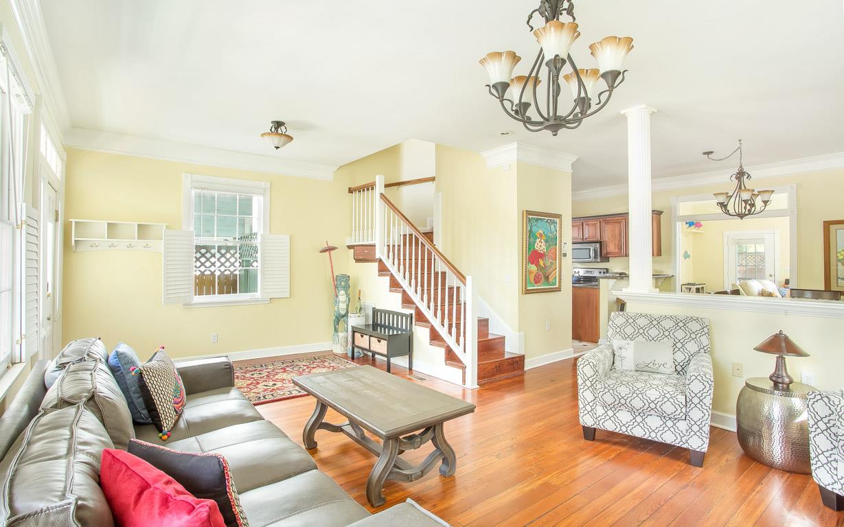 The living room leads to both the stairwell and the kitchen.