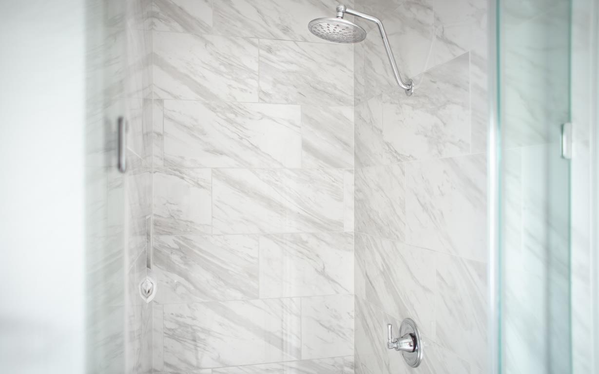 Enjoy a marbled standing shower.