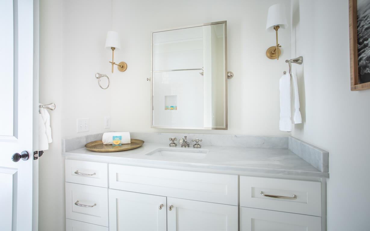 A full bath is just off the hallway, and shared by two guest rooms.