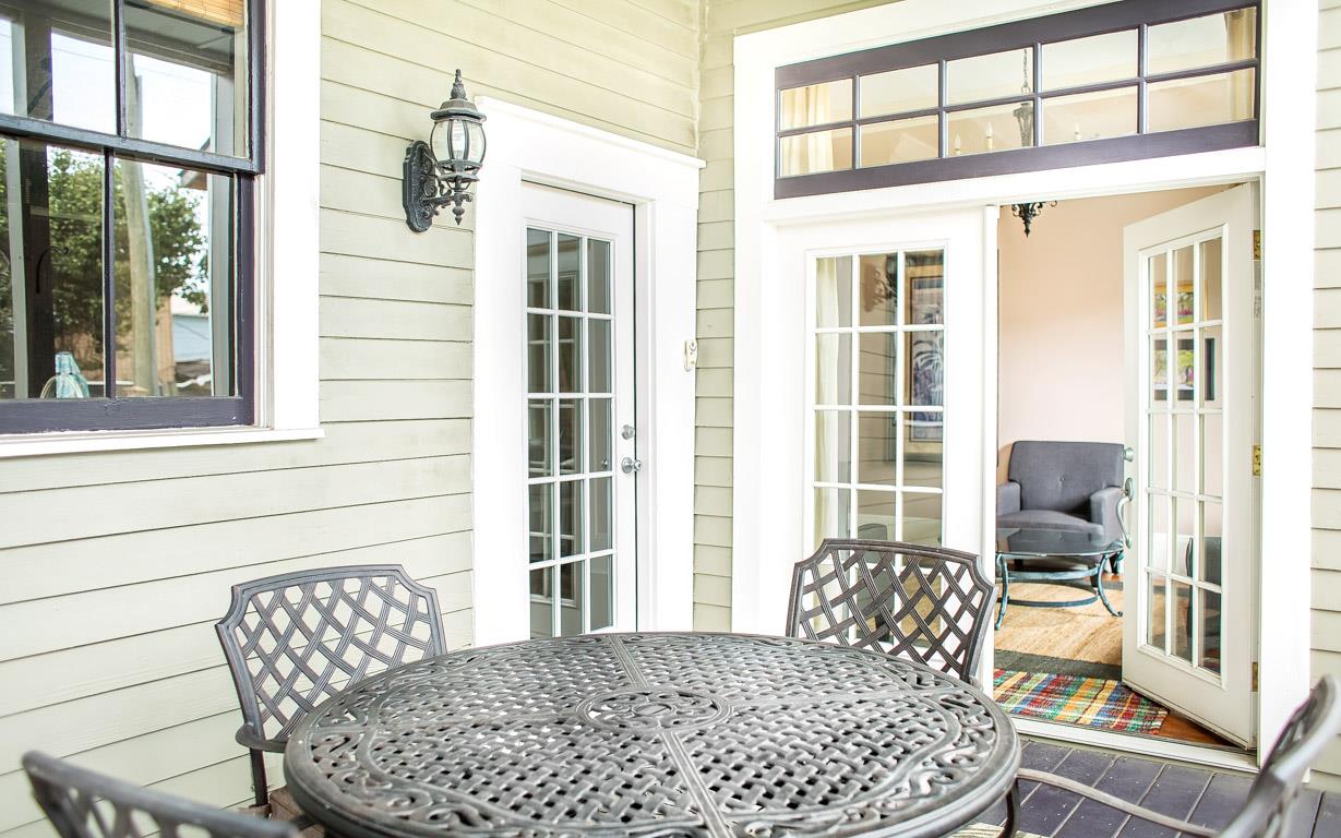 The screened in porch has seating for four.