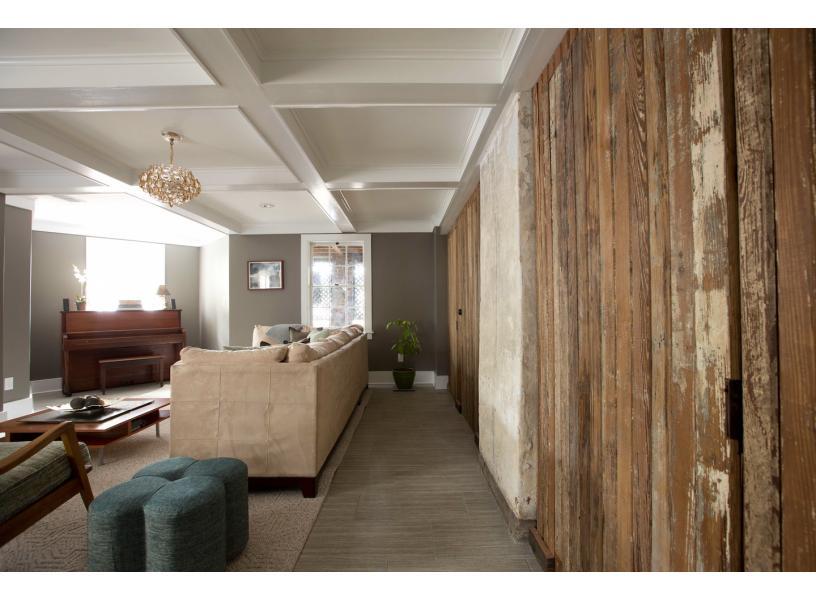 The reclaimed wood is carried on from the kitchen into the living room.