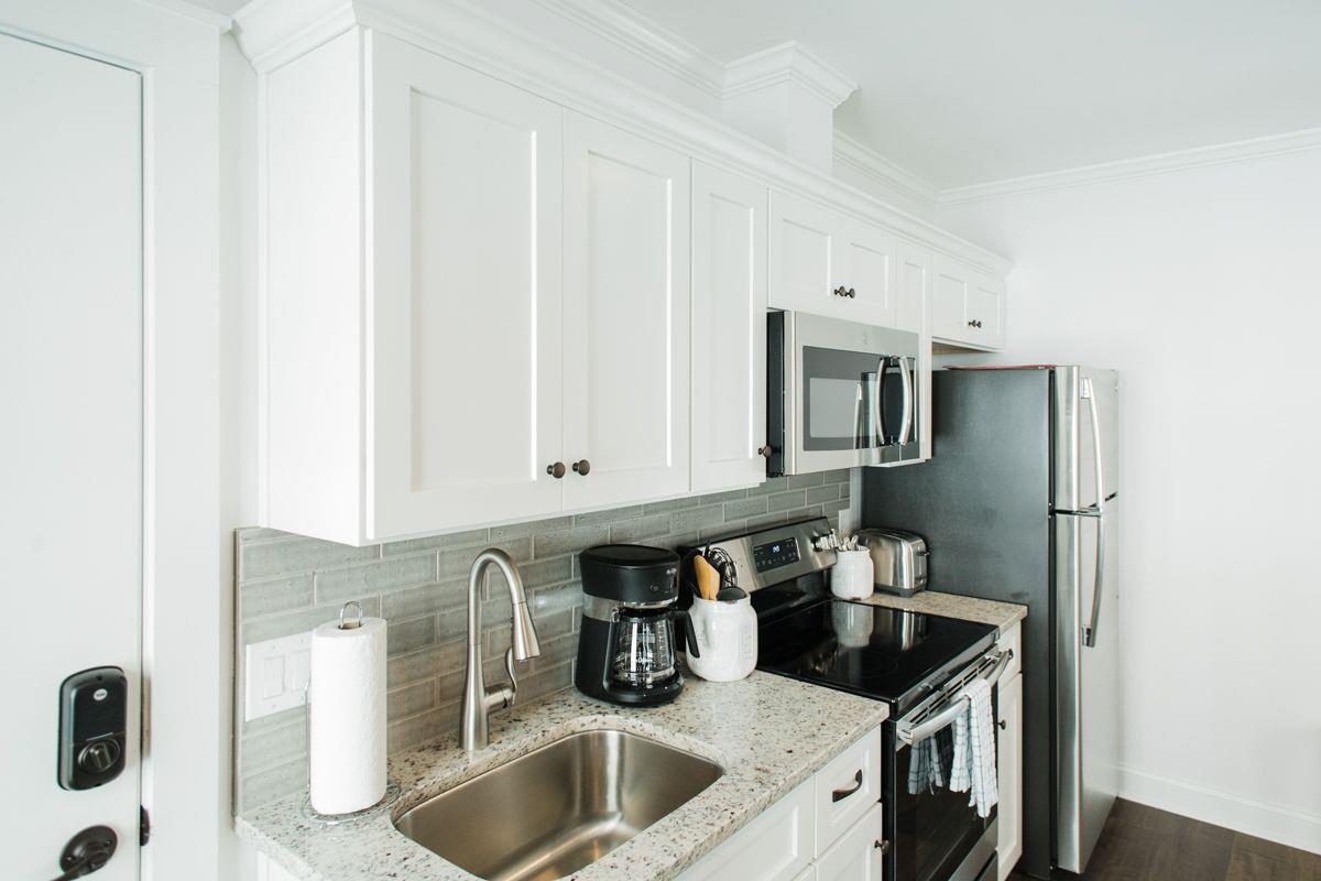 Granite countertops are complimented with a tiled backsplash.