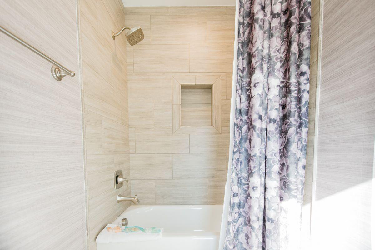 The tiled shower and tub combination is a great way to unwind.