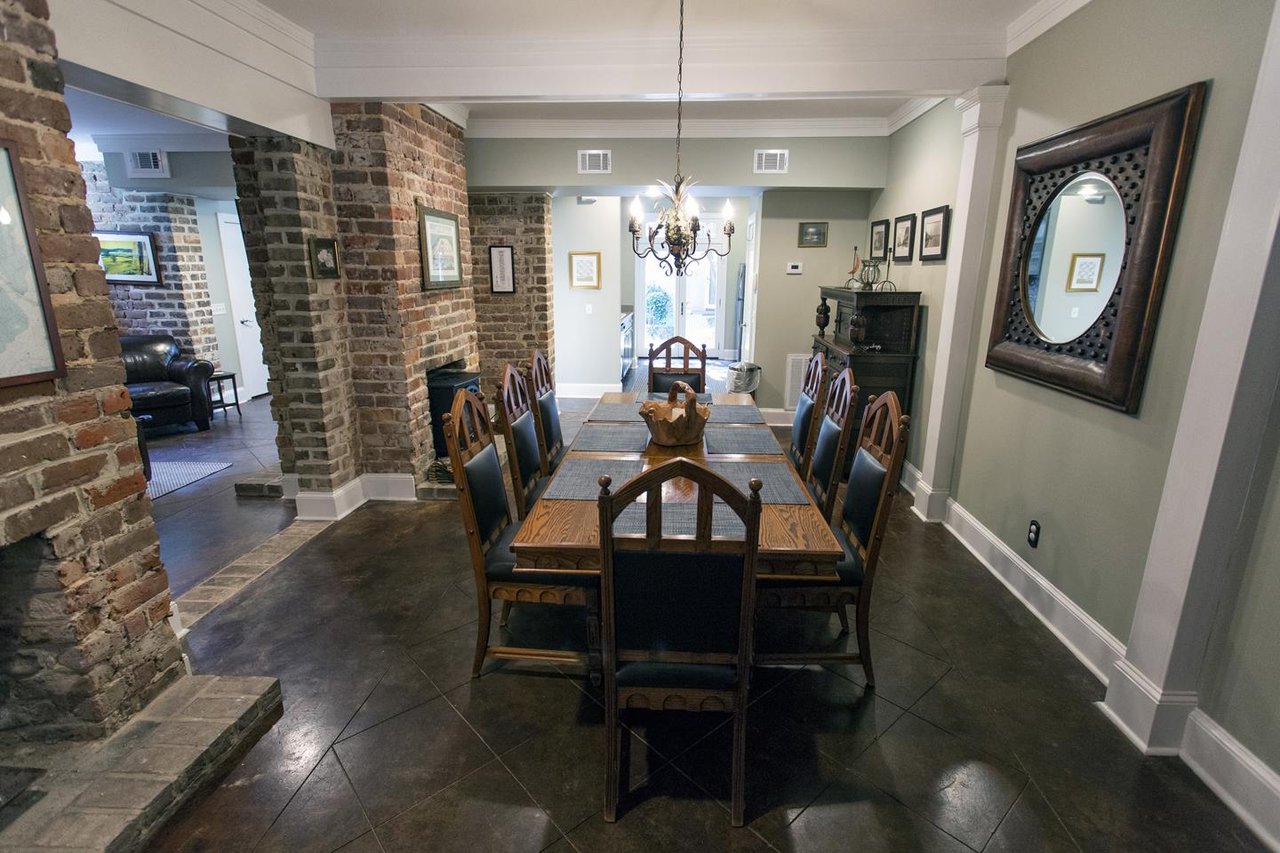 Original brick walls and lots of open space create an elegant dining room area.