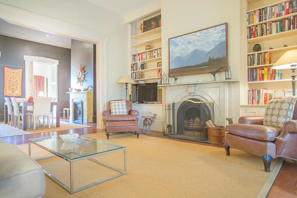 A flat screen TV is just left of the original fireplace  now decorative.