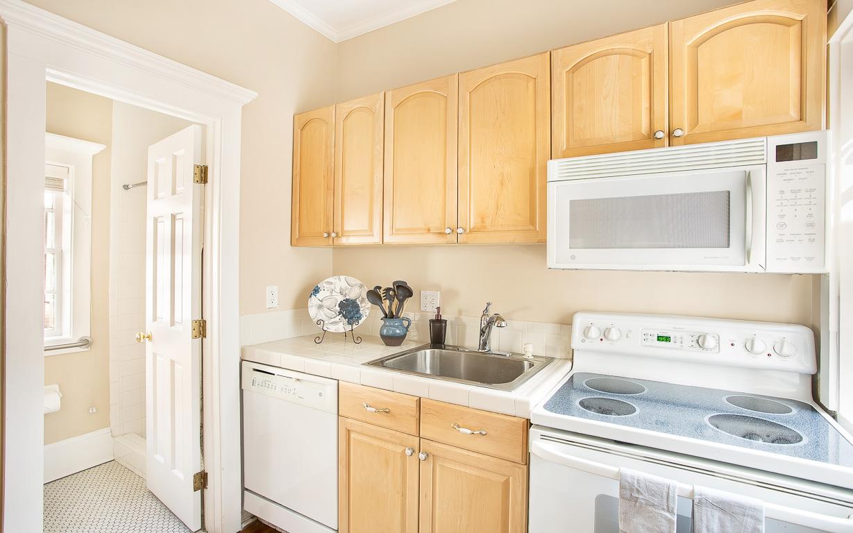A full size kitchen can be found behind the bedroom.