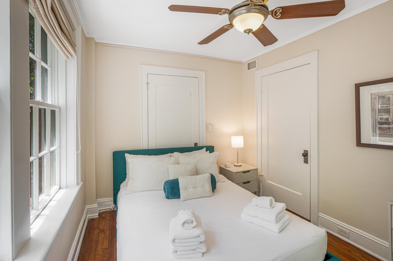 The bedroom windows feature blackout curtains, a ceiling fan, and a sound machine for those deep sleepers