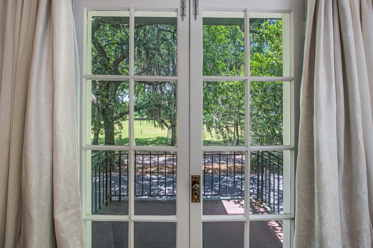 The balcony doors open to a charming space, that allow a comfortable breeze into the bedroom.