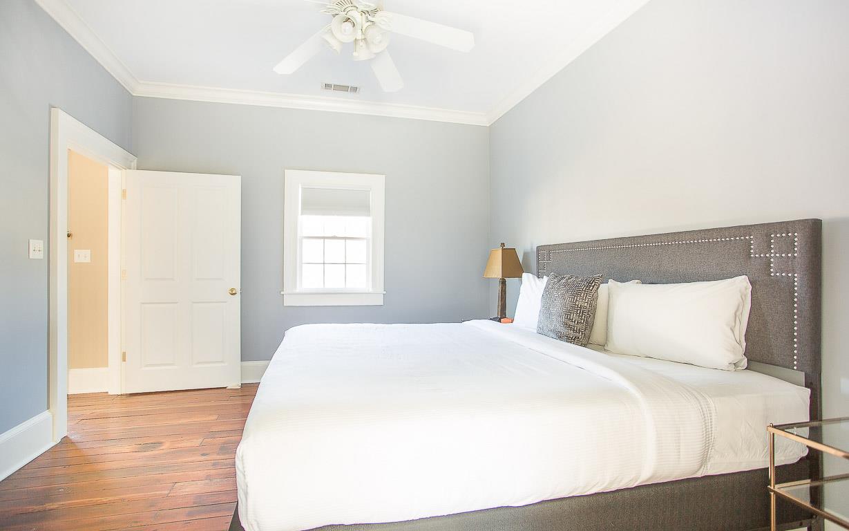 Feel right at home with a tufted headboard and flat screen TV.