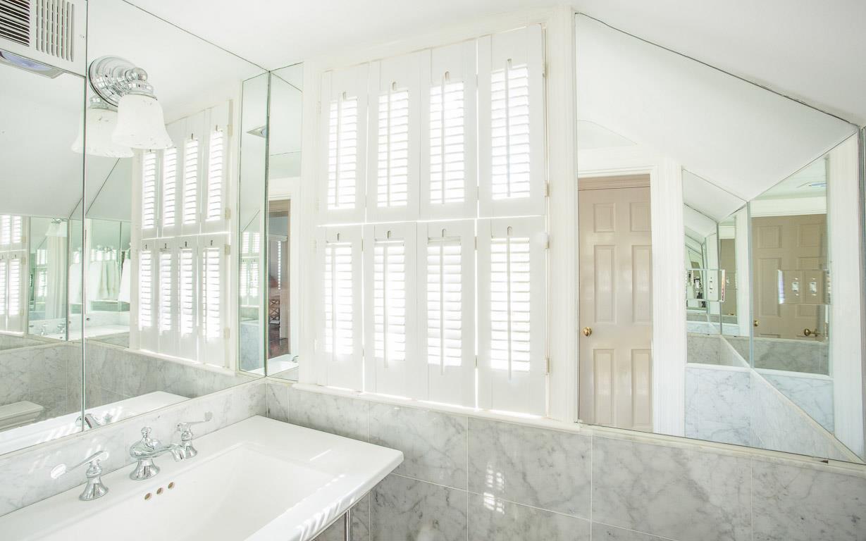 A half bath is located beneath the main entry stairs.