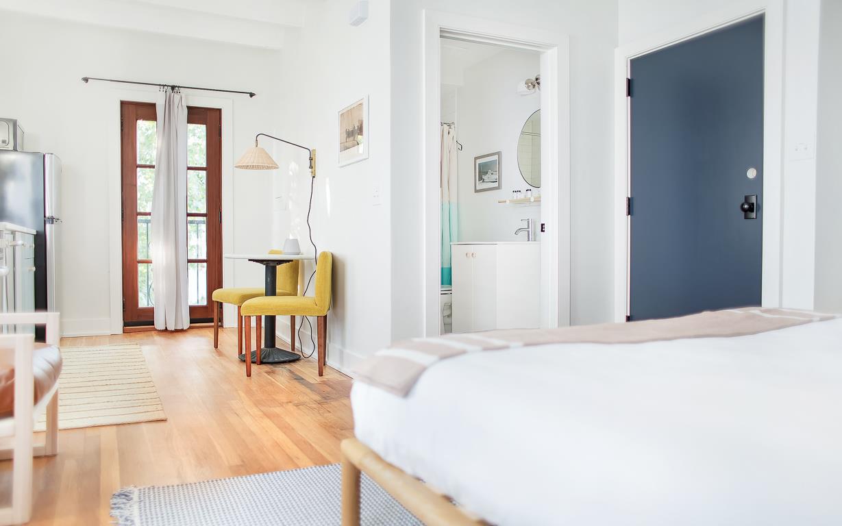 The bath is opposite the bed.