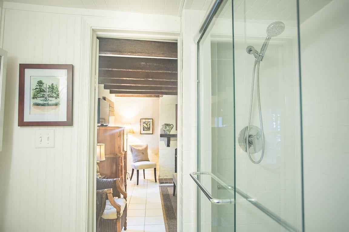 A standing shower can be found in the bathroom.