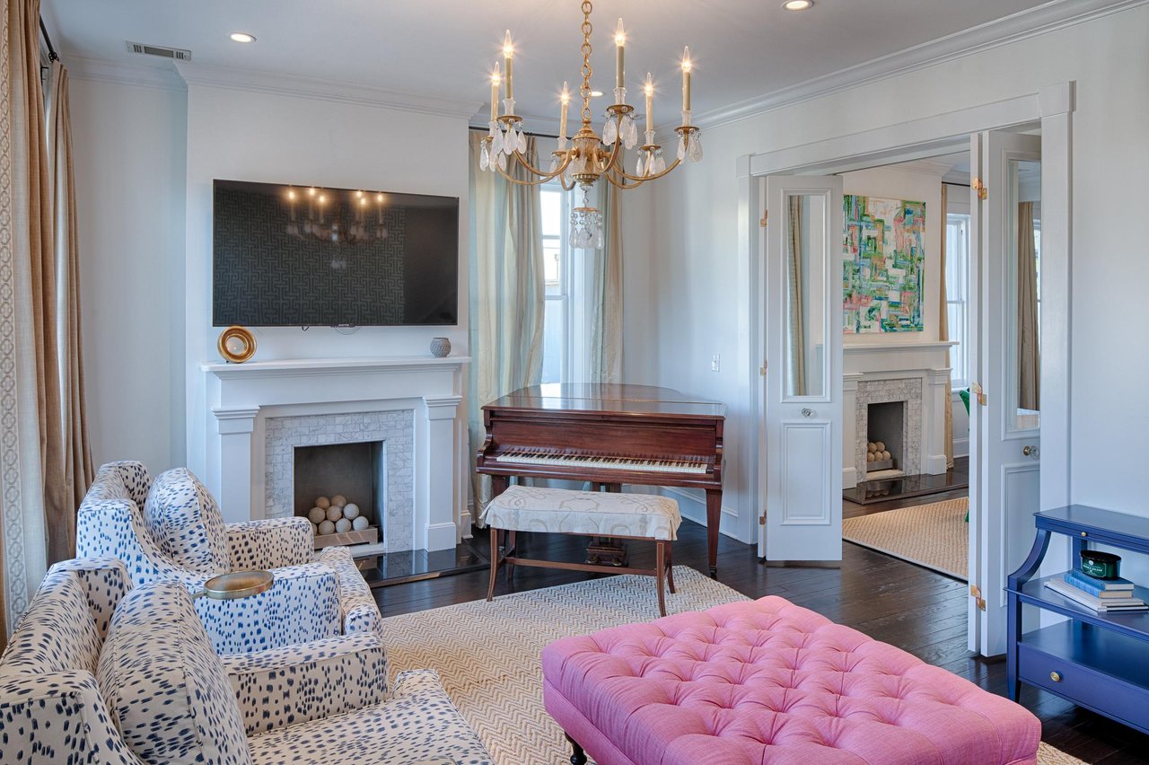 The decorative fireplace, and grand piano truly bring this space to life.