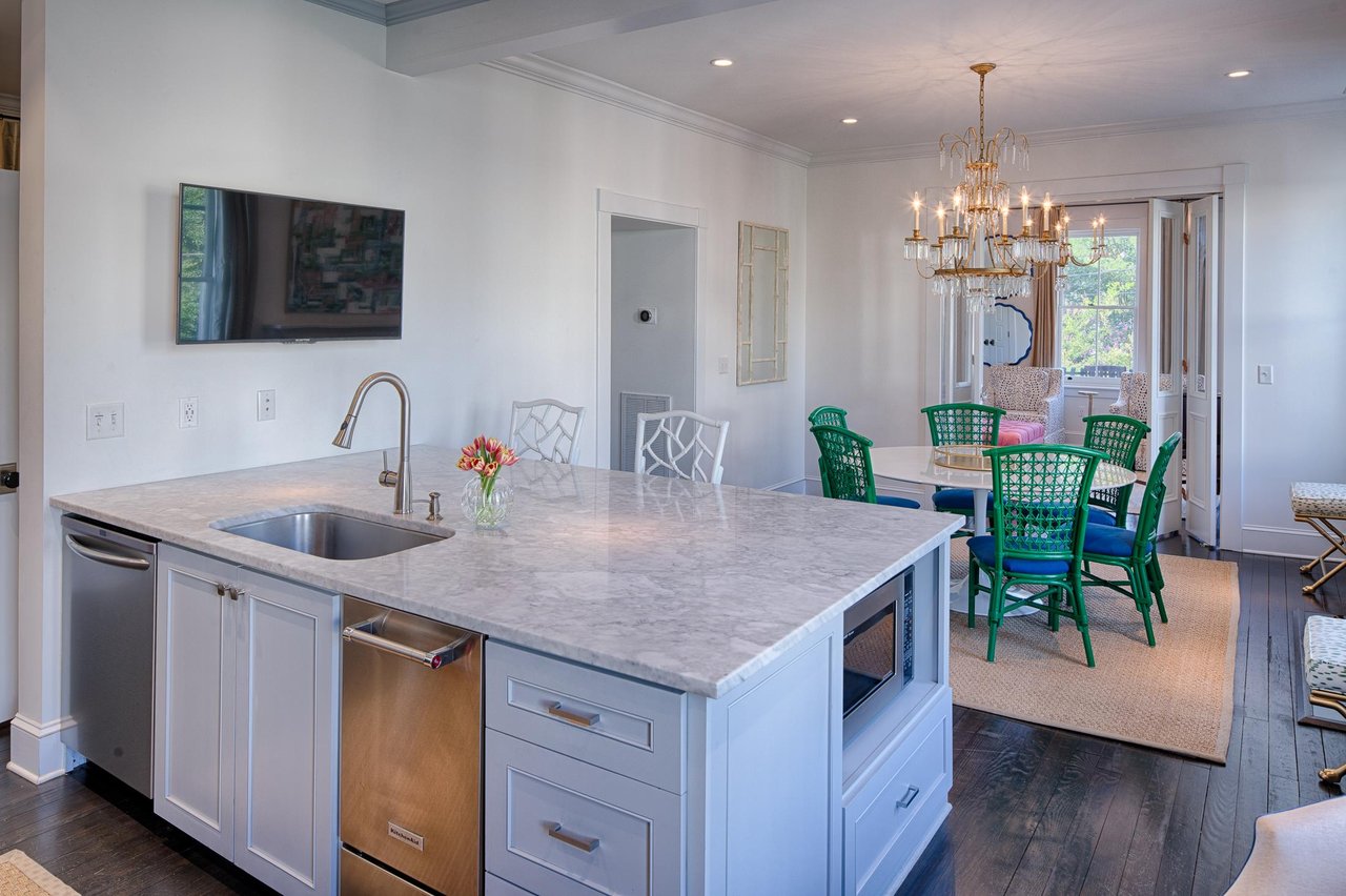 The large custom island serves as additional eating, and meal prepping space.