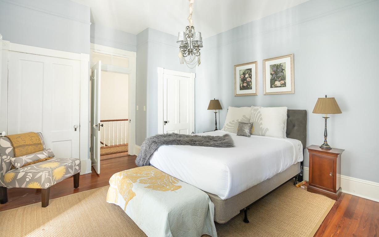 The primary bedroom is the first bedroom off of the stairs.