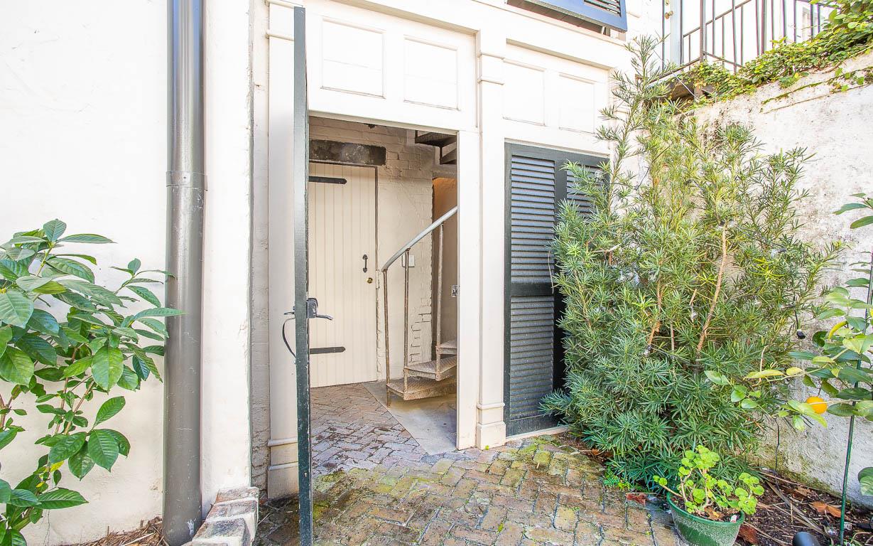 Enter the shared courtyard space, just behind your carriage house.