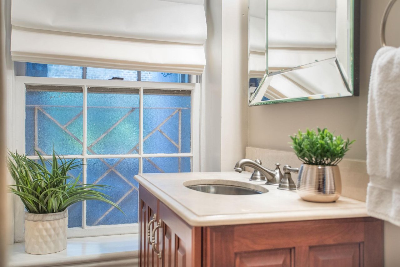 The full bath has a single vanity and walkin shower.