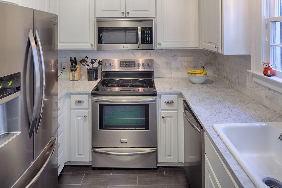 The kitchen is fully equipped with new stainless steel appliances.