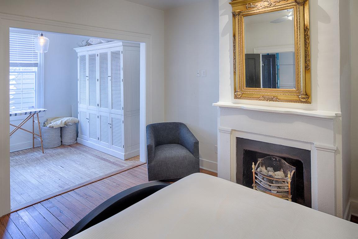 The bedroom opens up to a walkin closet with ironing board.