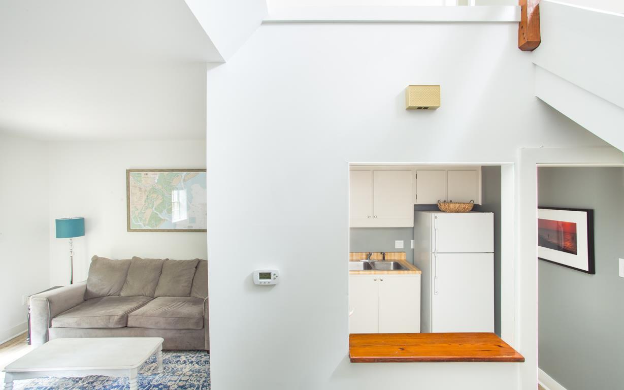 View of the kitchen service window and the nearby living room.