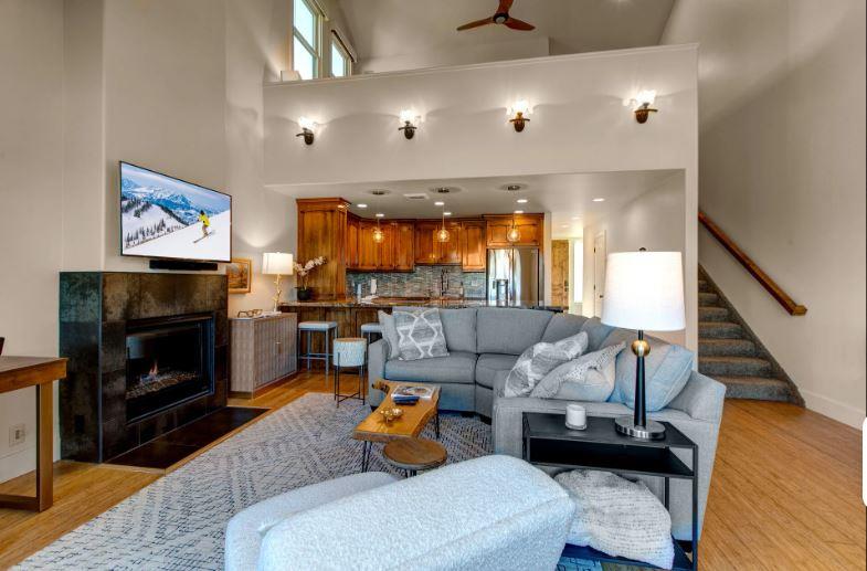 Openconcept living room offers a gas fireplace, seamlessly connected to the kitchen for easy entertaining and relaxation.