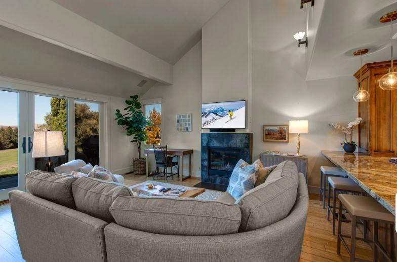 Comfortable living room with 50” smart TV, gas fireplace, and work desk