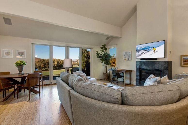 Comfortable living room with 50” smart TV, gas fireplace, and work desk