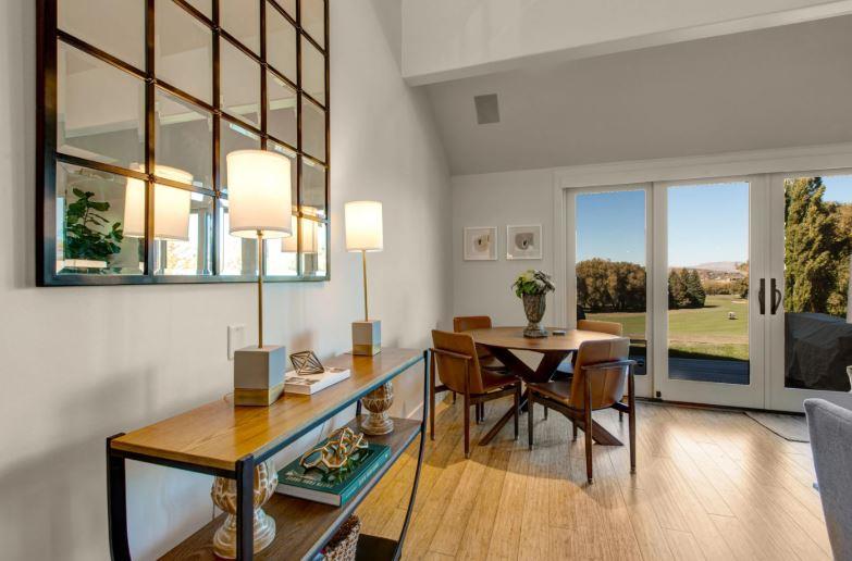 Dining area with a table and chairs for four guests.