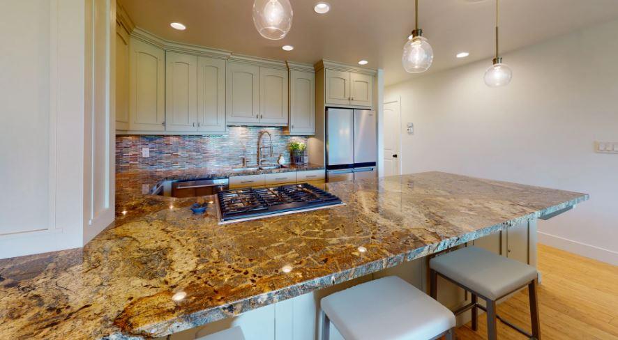Modern, fully equipped kitchen with luxury granite countertops, updated appliances, and ample cabinet space.