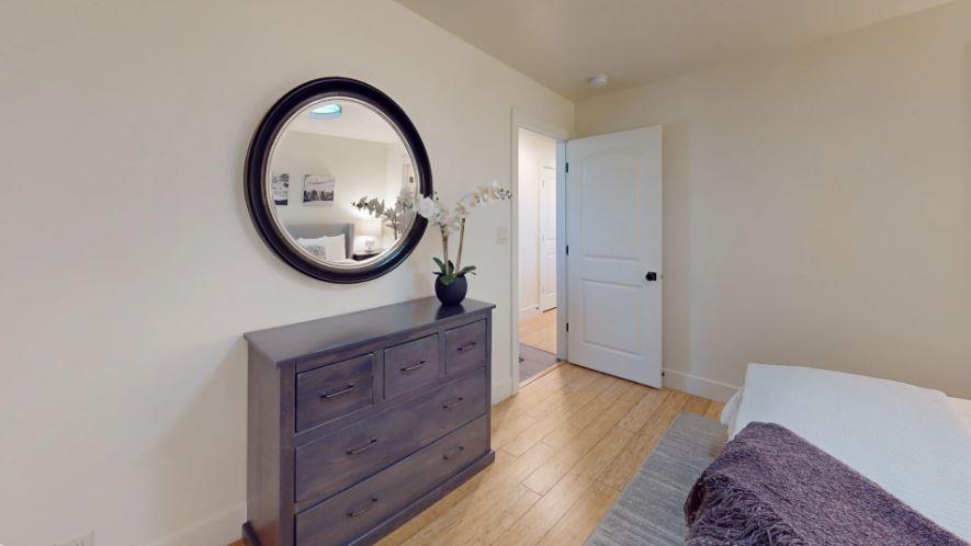 Luxurious downstairs master suite featuring a king bed and a private ensuite bathroom.