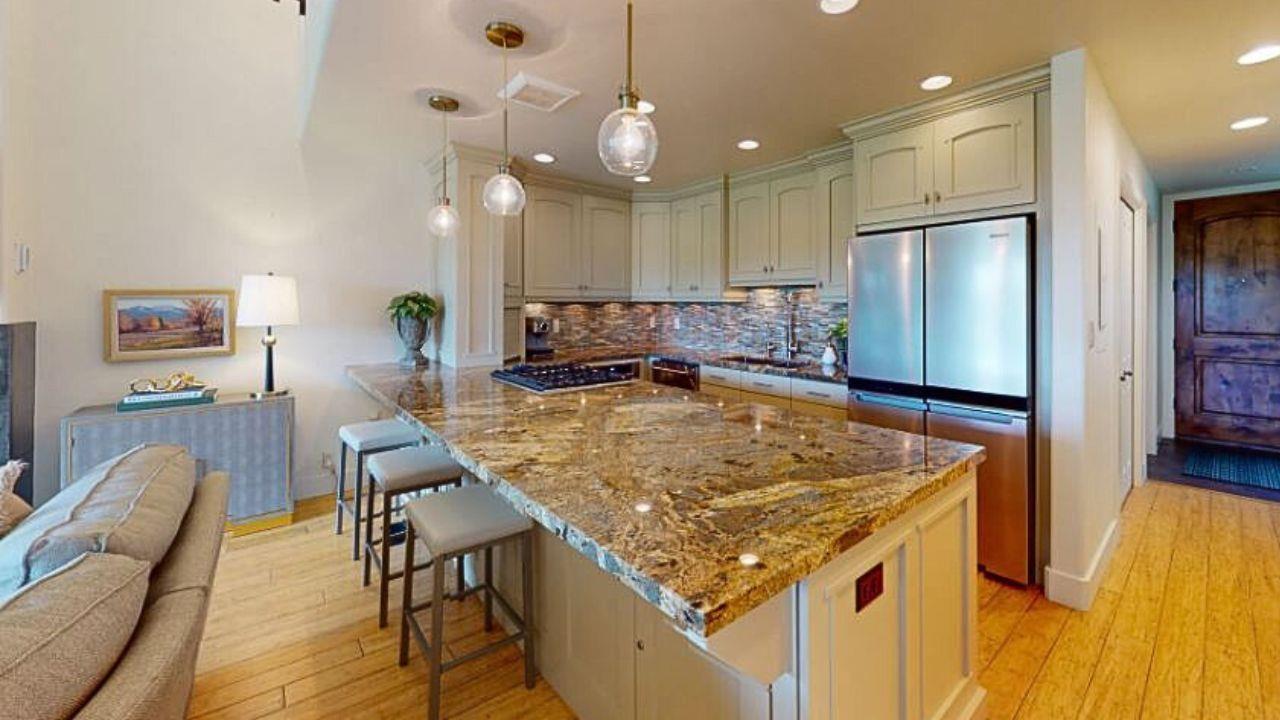 Modern, fully equipped kitchen with luxury granite countertops, updated appliances, and ample cabinet space.