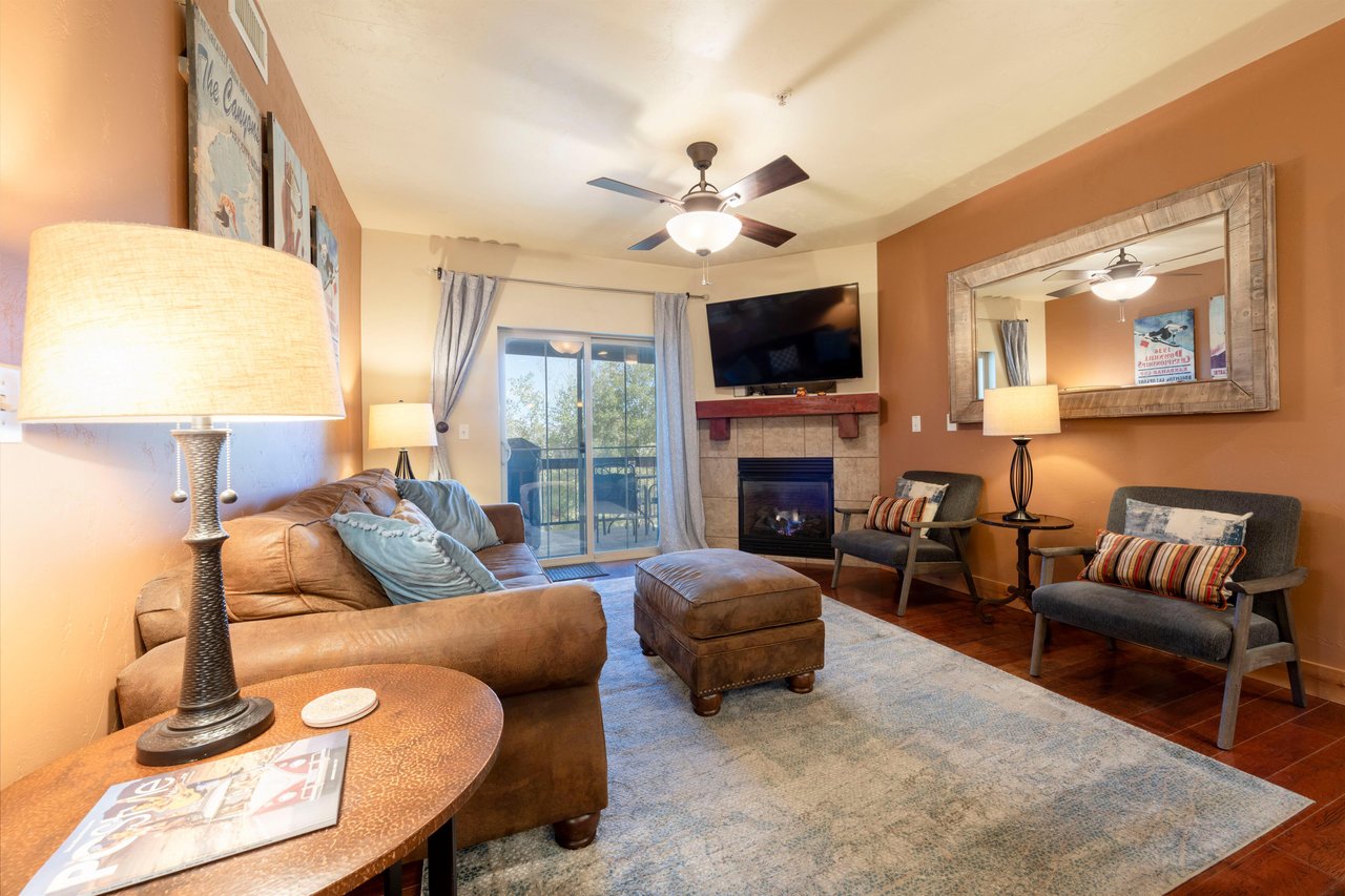 Living room offers cozy seating and balcony showcasing stunning views