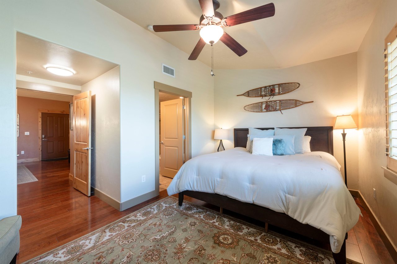 Master bedroom features hardwood floors and 50 inch LED Tv.